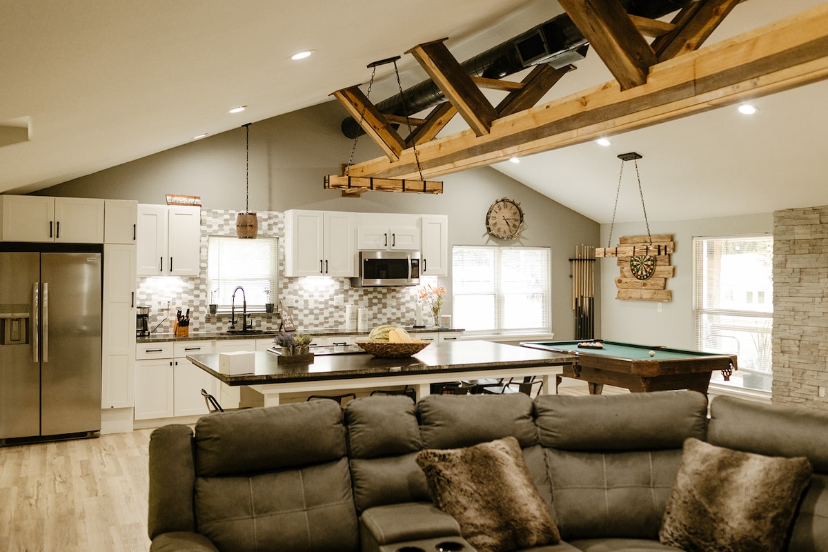 Open living room, kitchen, and pool table inside Running Water Cabin