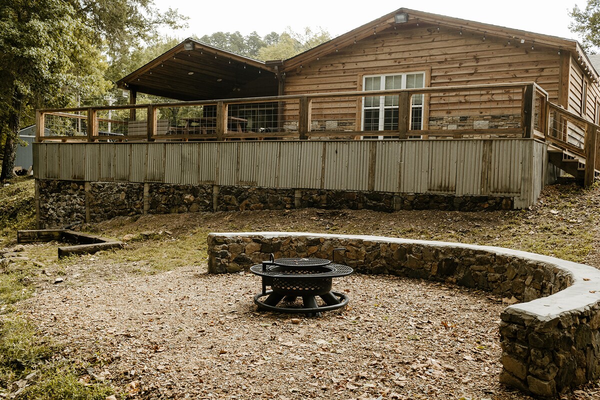 Stone fire pit area below the large cabin deck