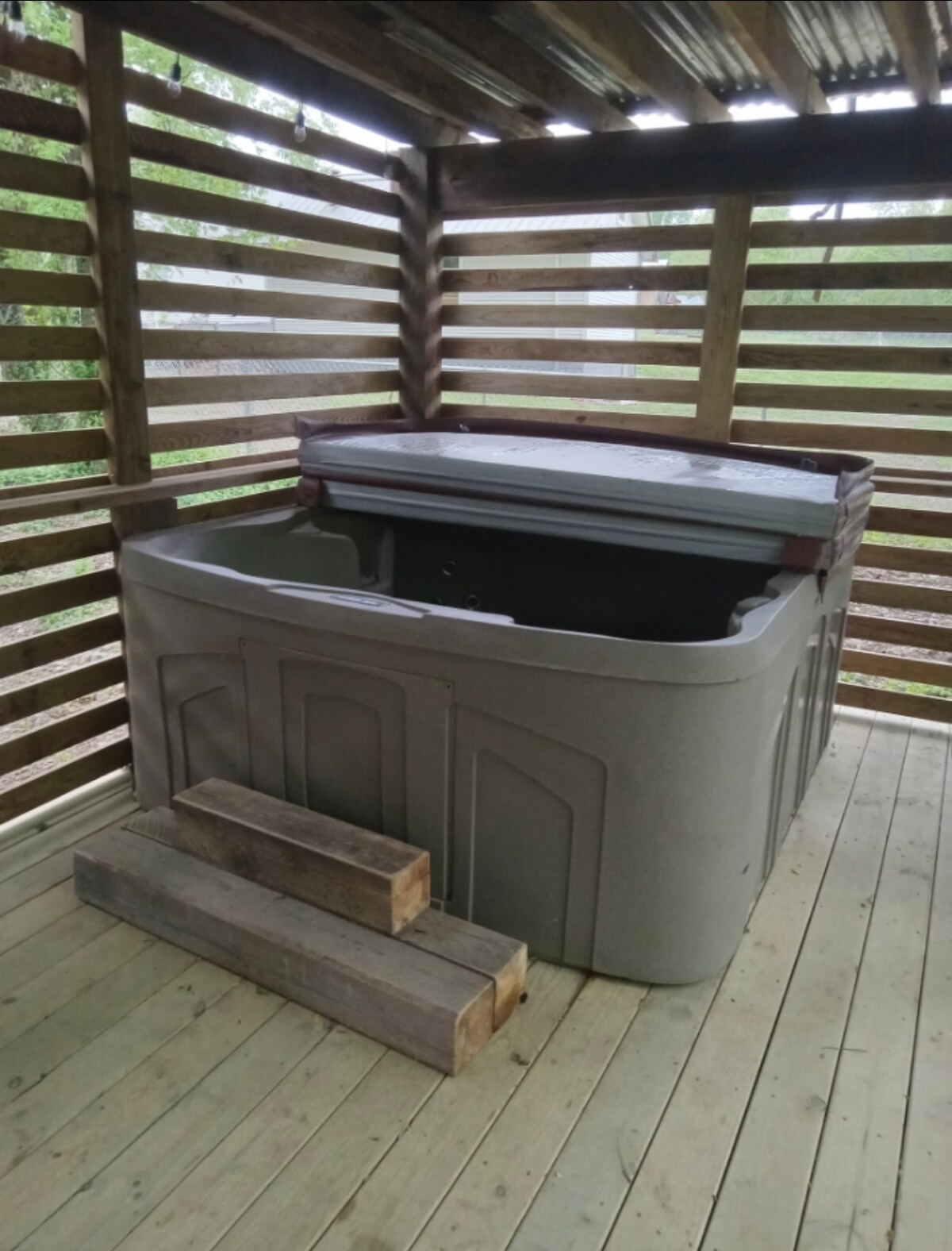 Hot tub on the covered tiny cabin deck